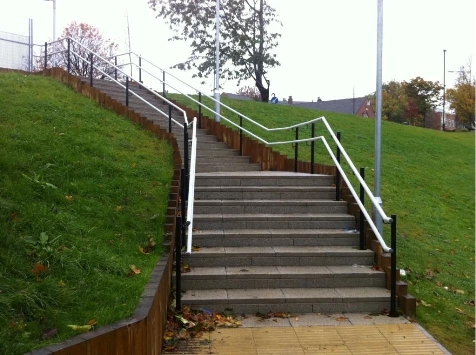 Twin height galvanised and powder coated external handrails to landscaped granite steps in Sheffield
